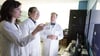 Pediatric epileptologists Julia Henry, MD, Chalongchai Phitsanuwong, MD, and Douglas Nordli, MD, reviewing information on a screen